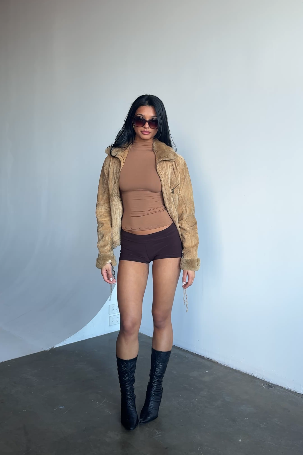 Women’s short sleeve turtleneck t shirt in a light brown colour, featuring smooth stretchy fabric with a sleek body hugging silhouette, perfect for layering or wearing on its own